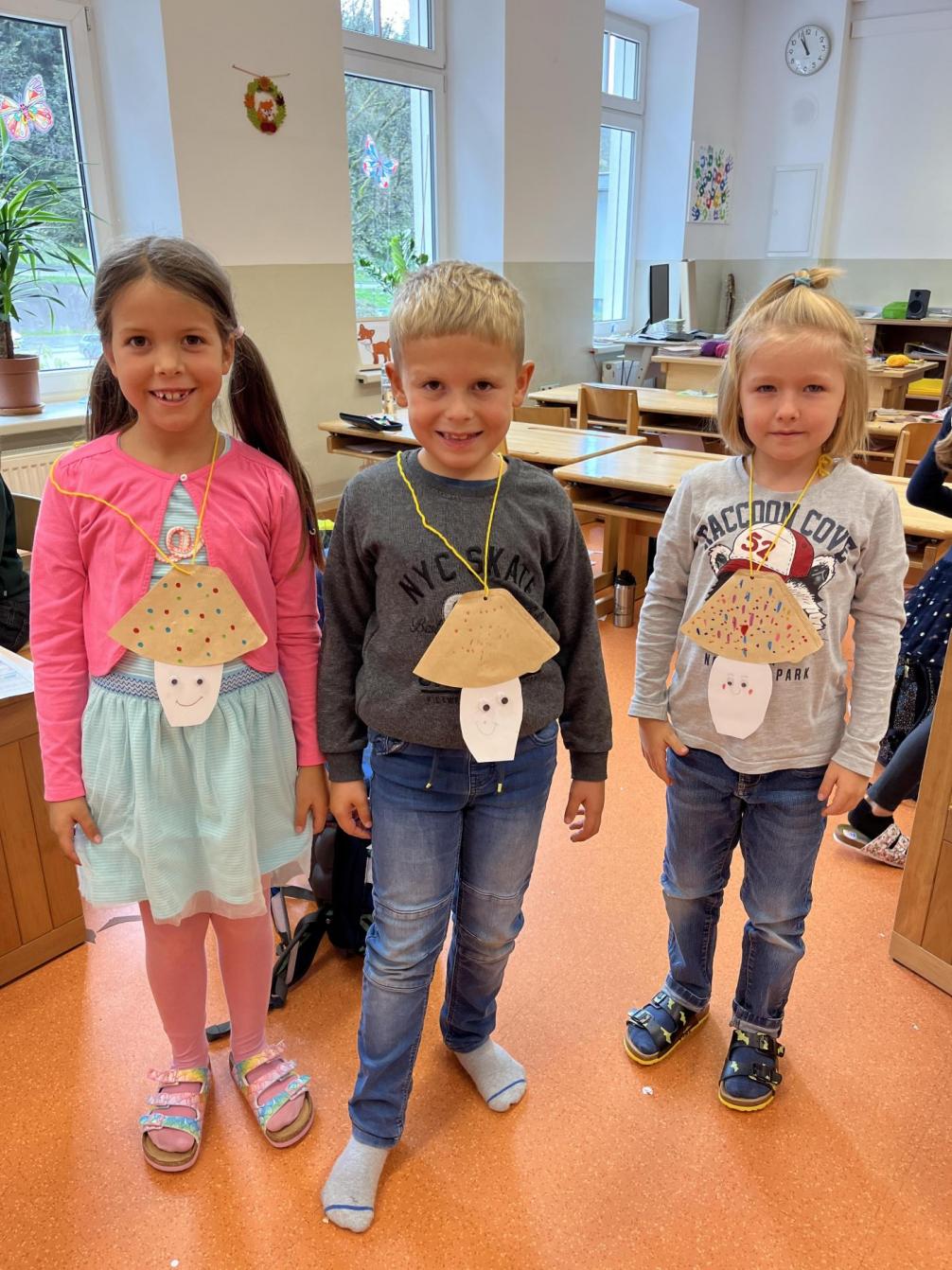 Kinder mit selbstgebastelten Pilzen