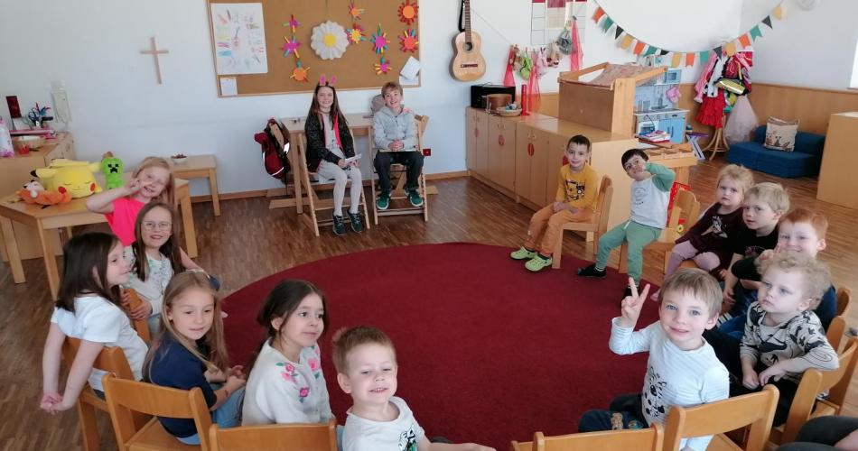 Volksschulkinder im Kindergarten beim Vorlesen